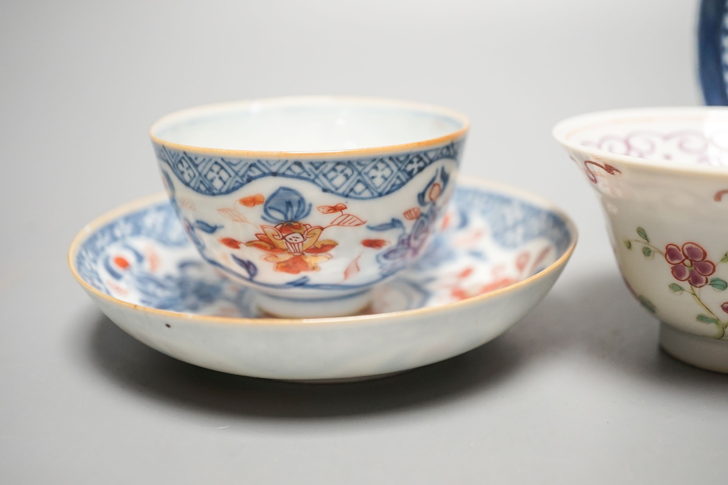 A Chinese Imari tea bowl and saucer, a famille rose tea bowl, a saucer and a celadon glazed cup